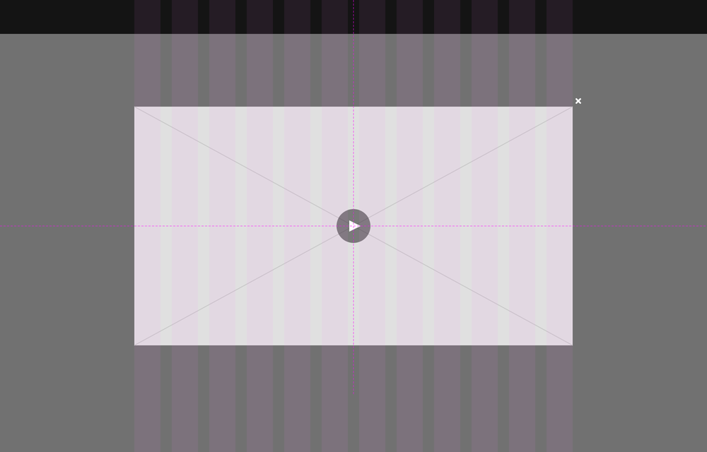 A dialog video player spanning a 12-column grid with a white close button