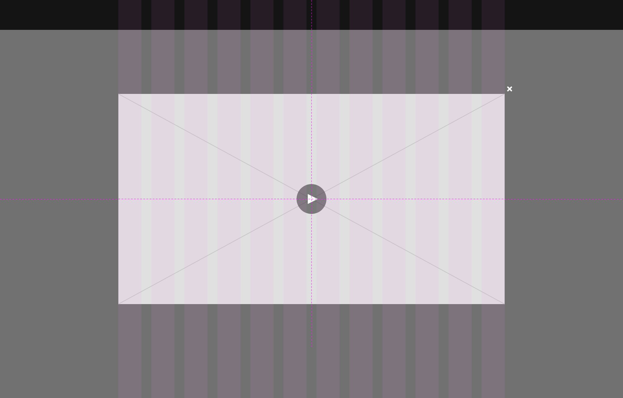 A dialog video player spanning a 12-column grid with a white close button